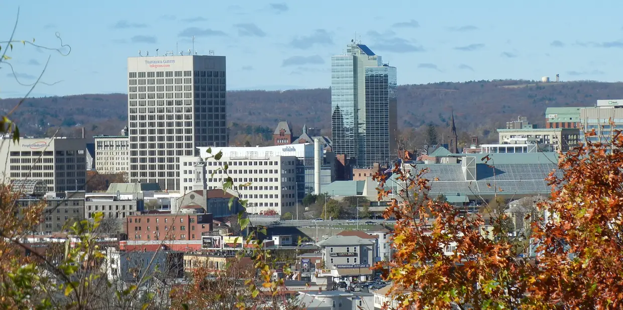 The downtown Worcester skyline above autumn trees